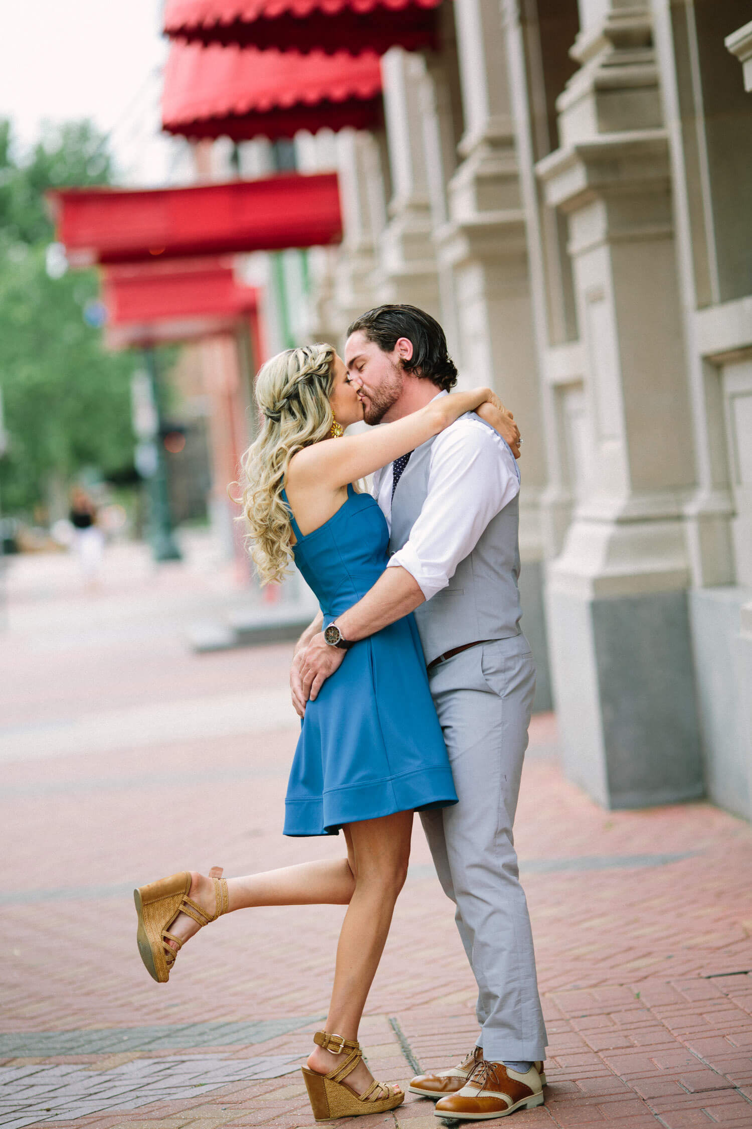 Engaged Houston couple taking photos in Market Square