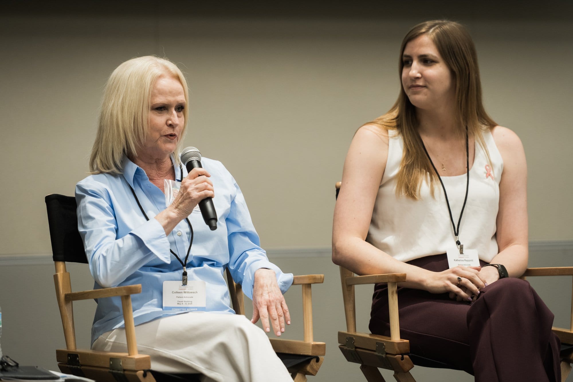 Conference photographer Houston: panel discussion in director's chairs