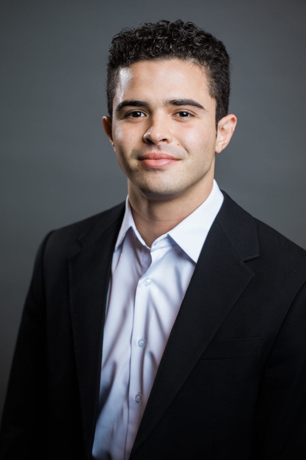 Corporate headshots photography: young man in a dark suit and white shirt
