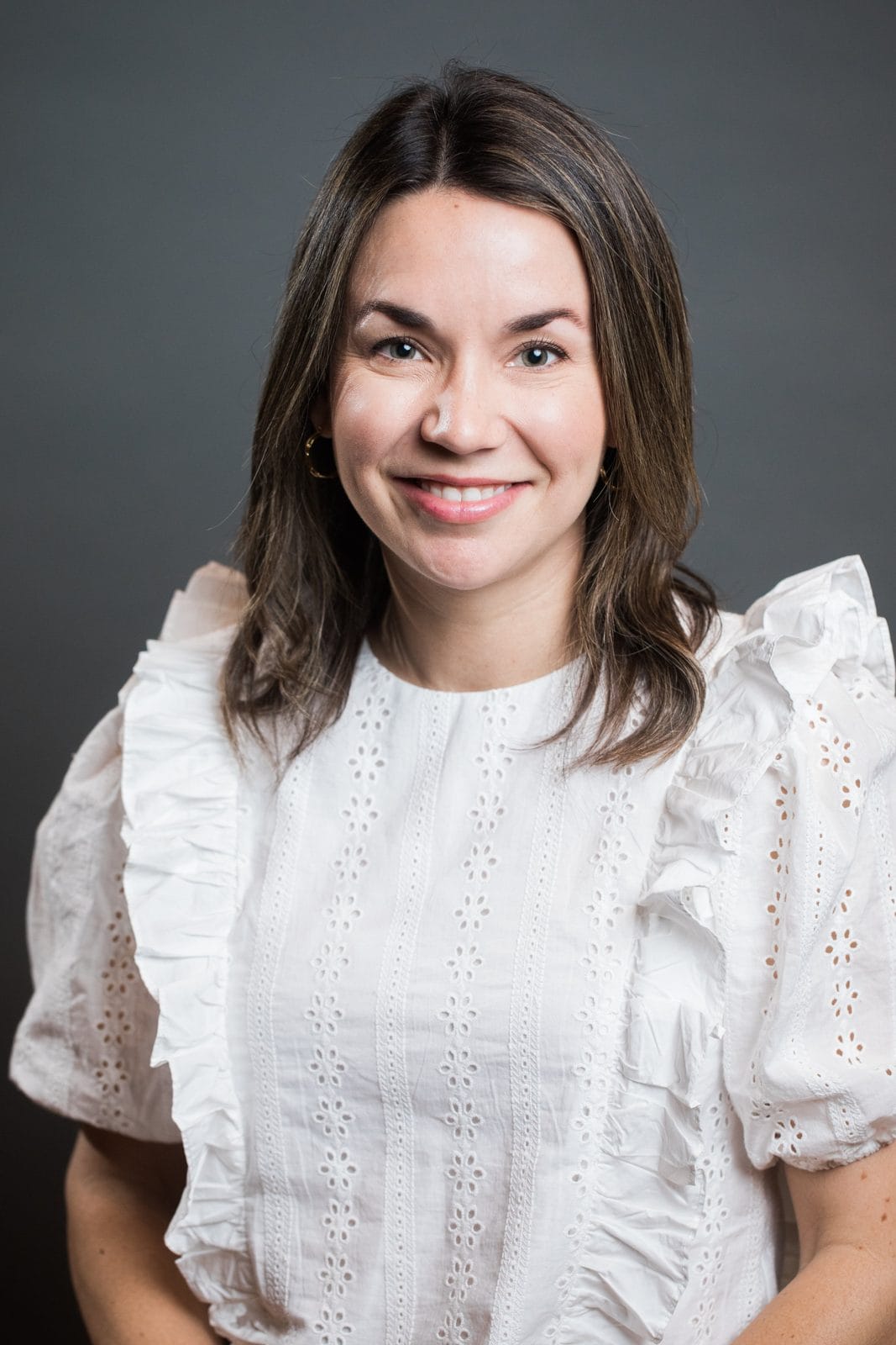 Headshots Houston Texas: woman in a white ruffled blouse