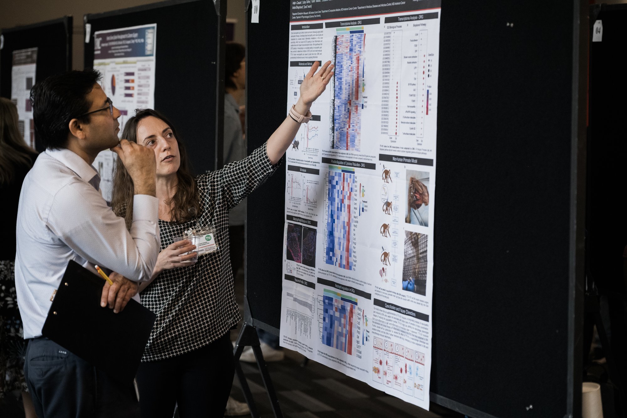 Houston event photography: presenter walks attendees through a research poster