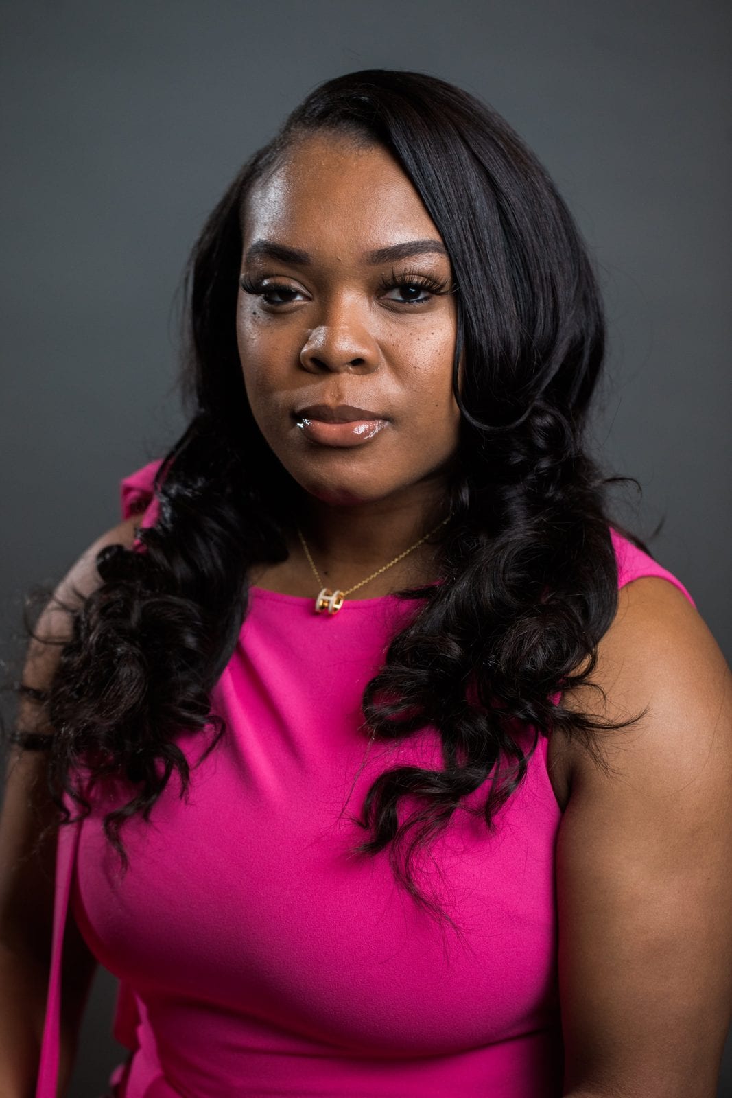 Professional headshot photographer Houston: woman in a pink dress